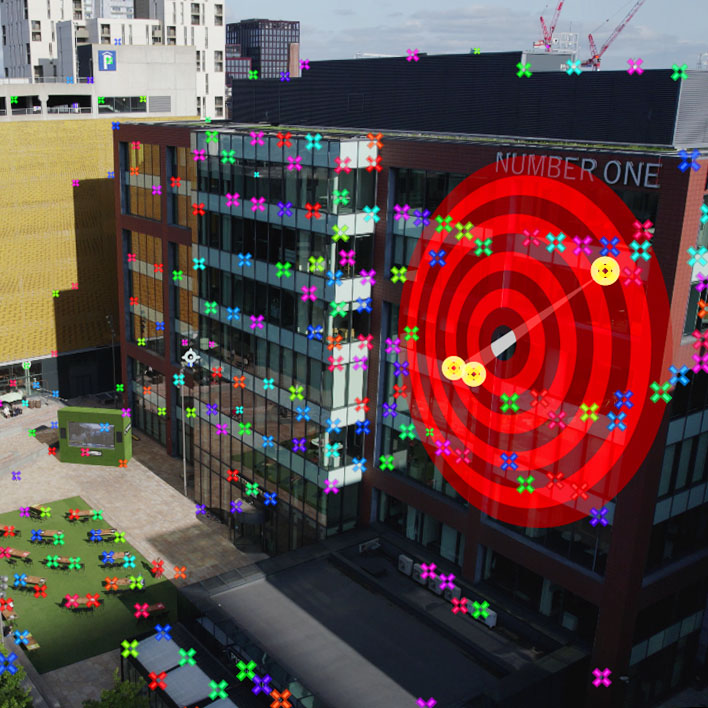 Camera tracking points from after effects and a target can be seen on a building after it has been 3D acmera tracked.